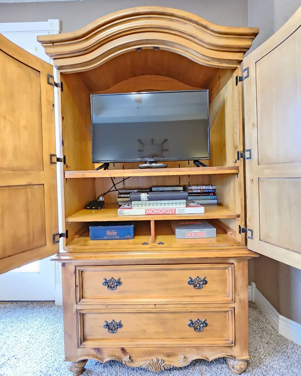 The armoire sports a TV with cable package, games, movie library, books, & more!