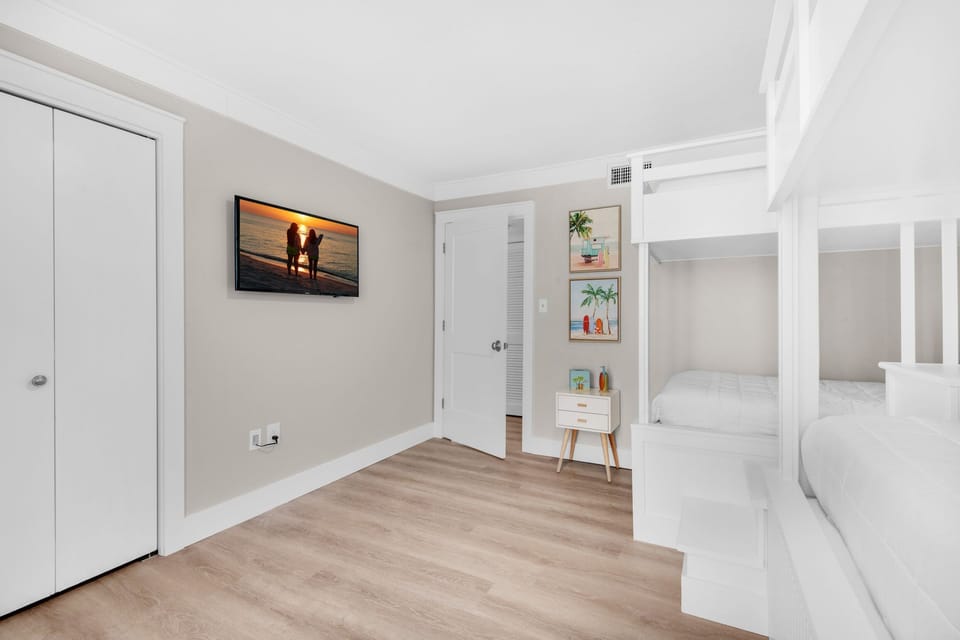 Bunk room with flat screen TV
