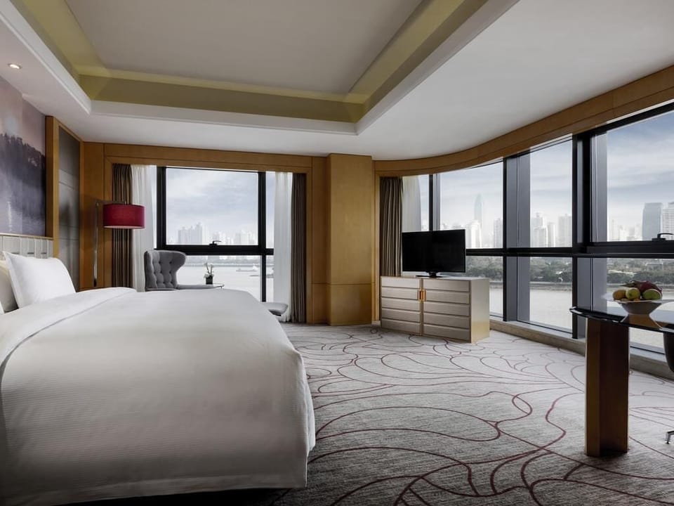 Premium Room, 1 King Bed, River View | Minibar, in-room safe, desk, laptop workspace