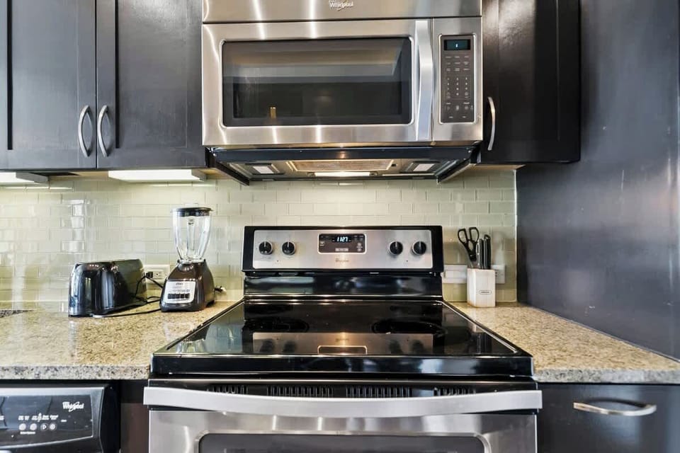 Modern appliances await your culinary adventures in this stylish setup!