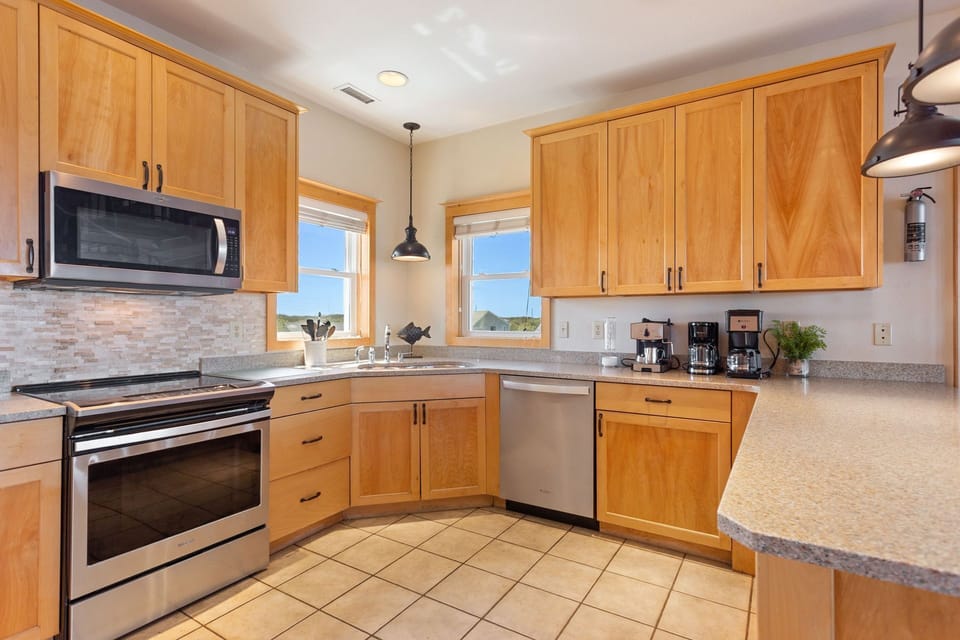 The fully equipped kitchen offers modern appliances and plenty of space for preparing coastal-inspired meals.