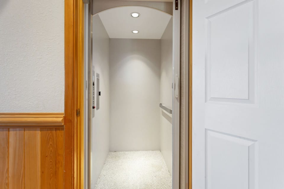 An elevator provides easy access between the ground, middle, and top levels of the home.