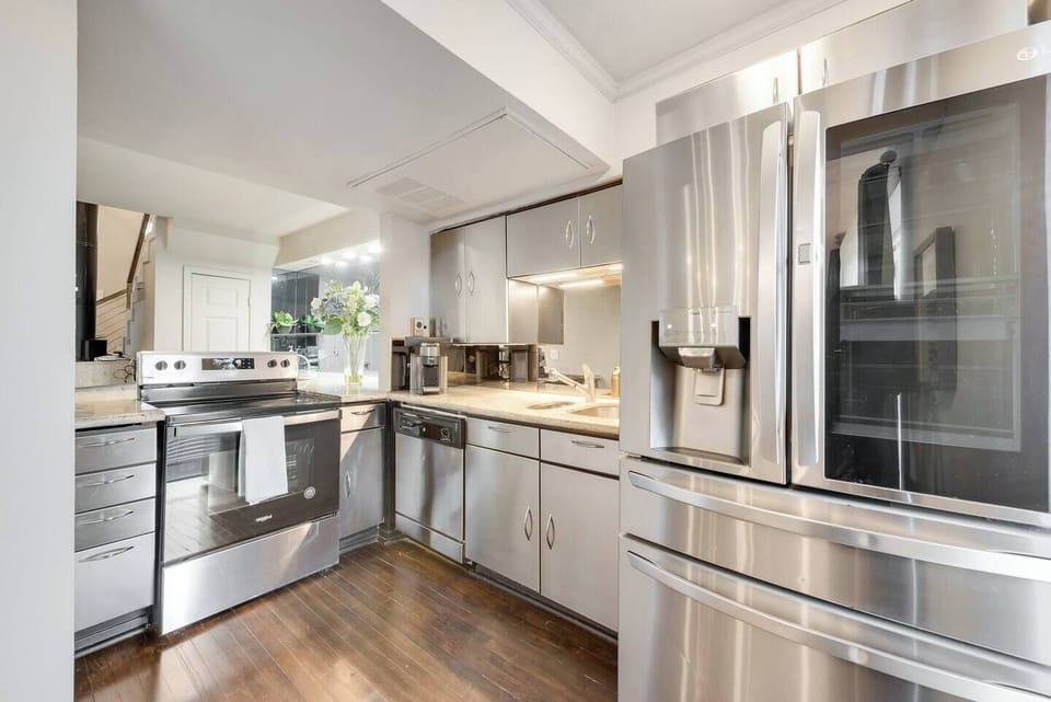 Spacious kitchen with sleek, modern appliances large refrigerator, fully equipped for all your cooking and dining needs.