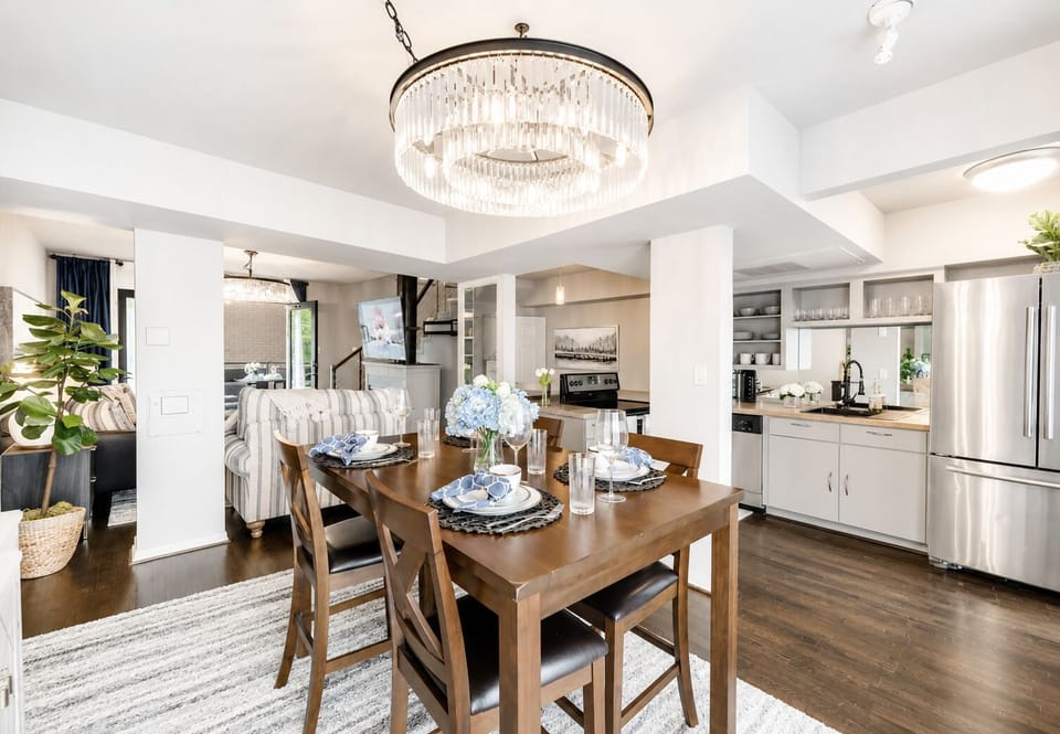 Open dining area with seating for four, featuring a beautiful chandelier..