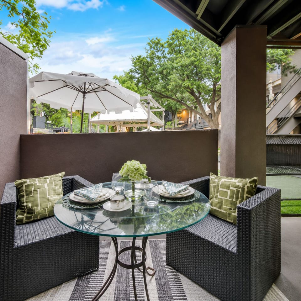Private balcony with bistro seating overlooking our Wellness Courtyard and pool