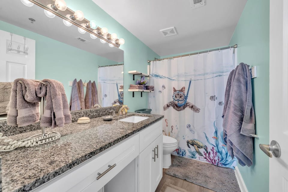 Master Bath w/tub shower, long granite vanity, convenient shelves, & hair dryer.