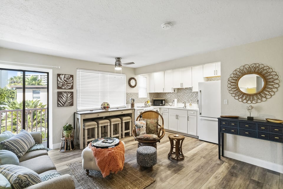 Ample seating of four stools at kitchen table overlooking the garden area/Upham beach and storage at front entrance in the custom-made dresser.