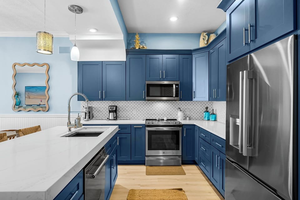 Fully equipped gourmet kitchen with granite countertops, stainless appliances, and everything needed for a group meal, plus a wine cooler/ice maker & kitchenette. 