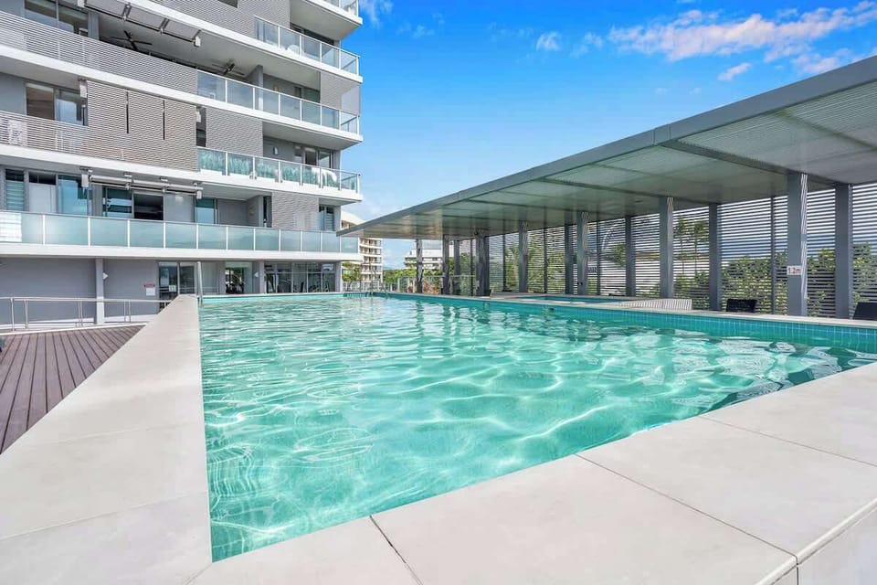 Spend sunny afternoons beside the shared pool, surrounded by tropical warmth and relaxed waterfront energy.