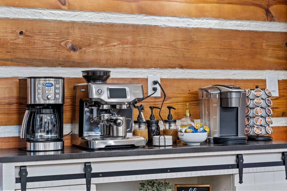A coffee bar with espresso machine and flavored syrups.