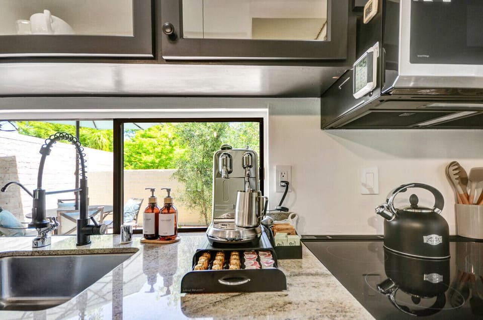 Grab your hot beverage from the Nespresso coffeemaker, drip coffee machine, or tea kettle with pods, sugar, and creamer provided.