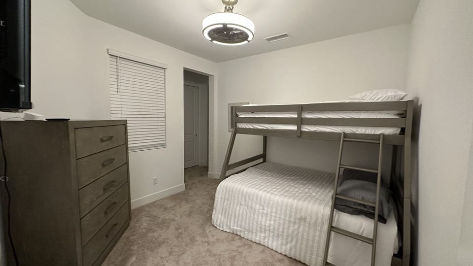 Bedroom 4 on first floor with queen bunk and twin on top, with full bathroom