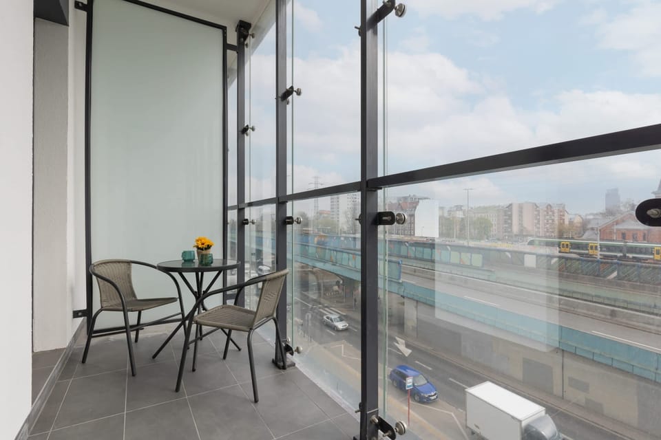 Spacious balcony with outdoor furniture. 