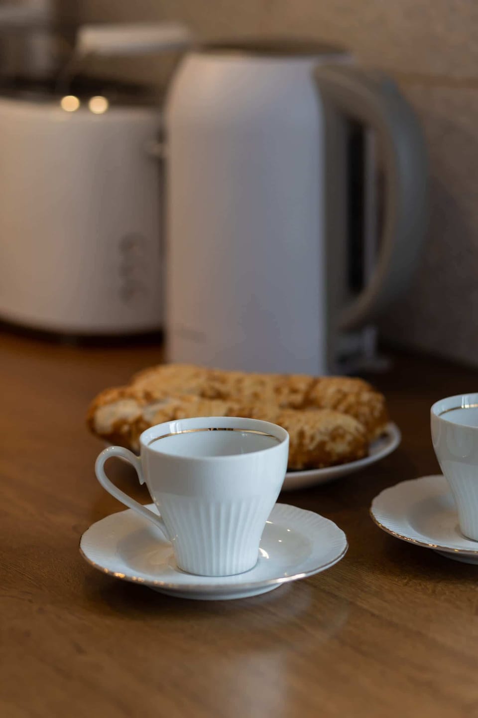 A close-up of a coffee set placed on the kitchen countertop, adding a homely touch.