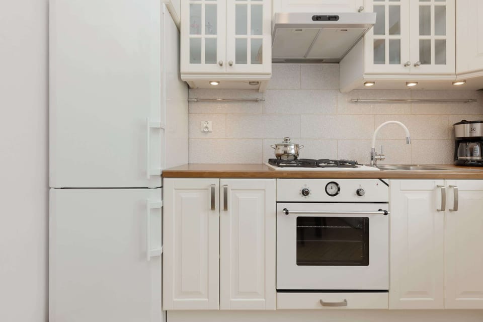 Another angle of the kitchen, showing the oven, gas hob, and practical storage in the cabinets.