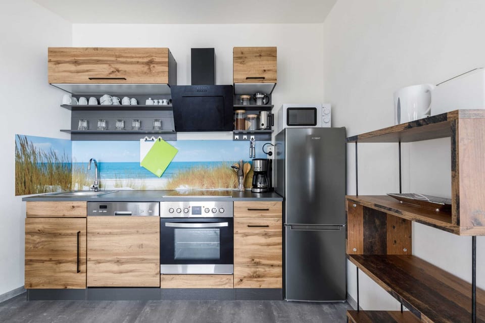 A focus on the decorative elements in the kitchen, such as plants and a colorful backsplash.