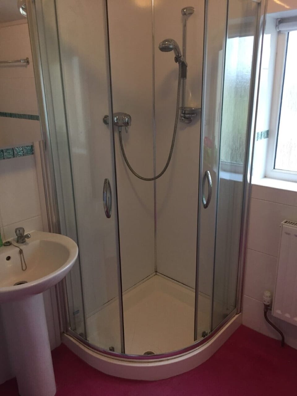 The shower and bath are in the same room. 