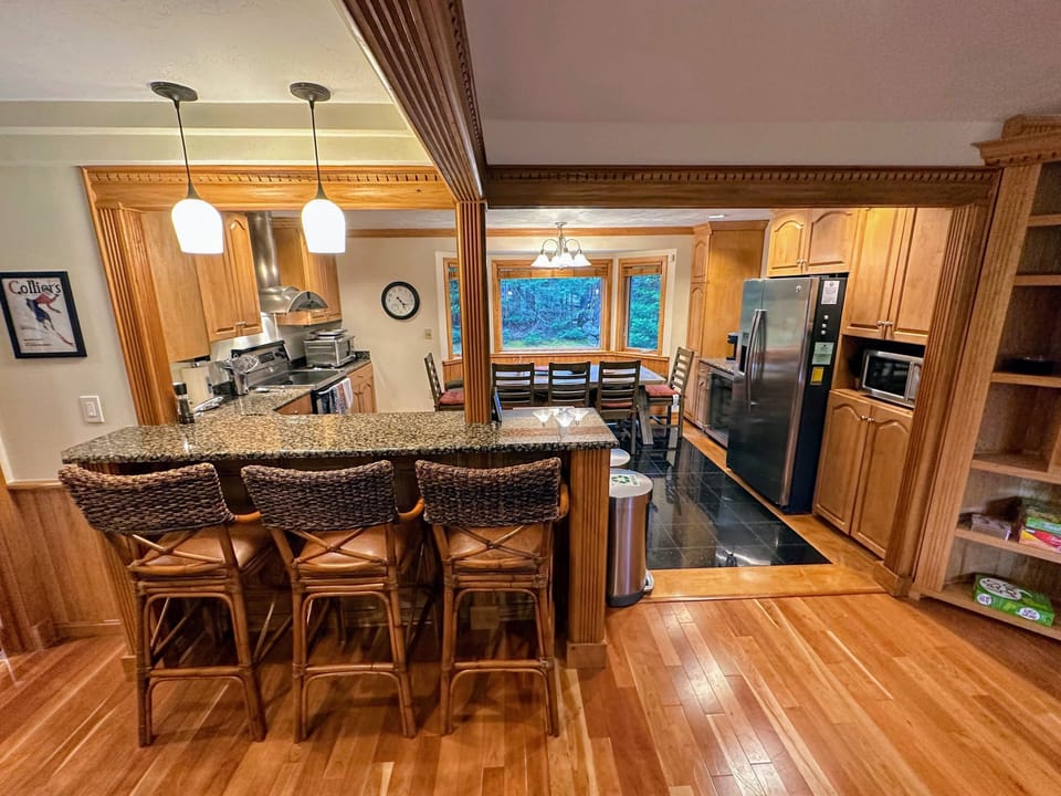 Kitchen with stainless appliances and dining table