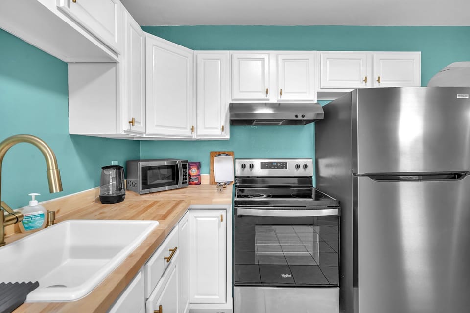 A generously sized kitchen, complete with the essential amenities and ample storage space for your culinary needs.