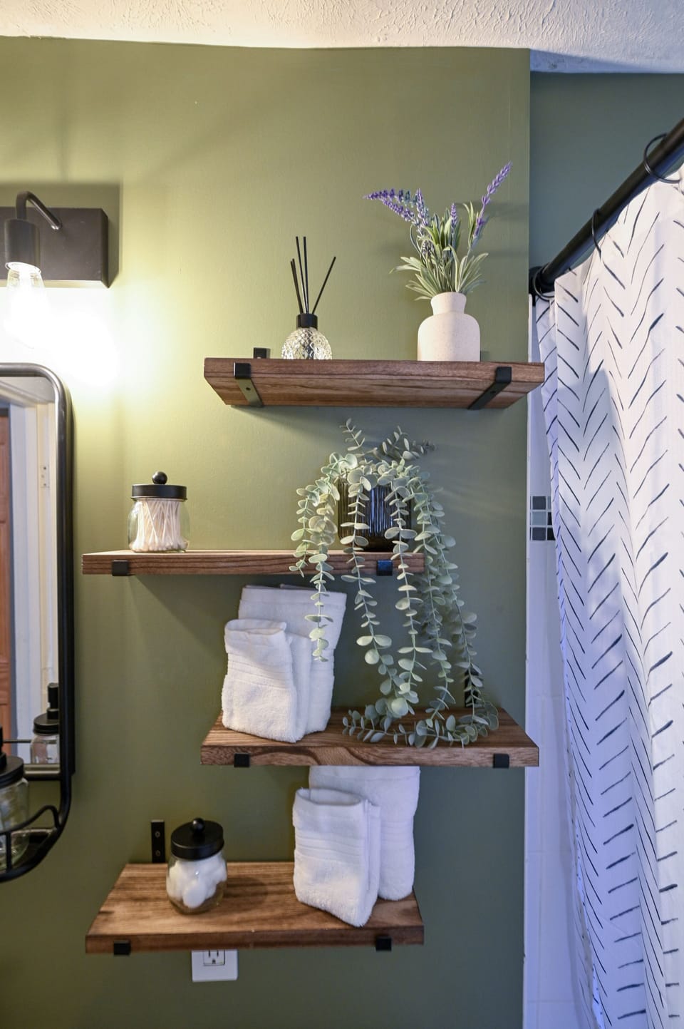 Stylish bathroom shelving with plush towels, plants, and aromatherapy touches creates a spa-like retreat for your daily rituals.