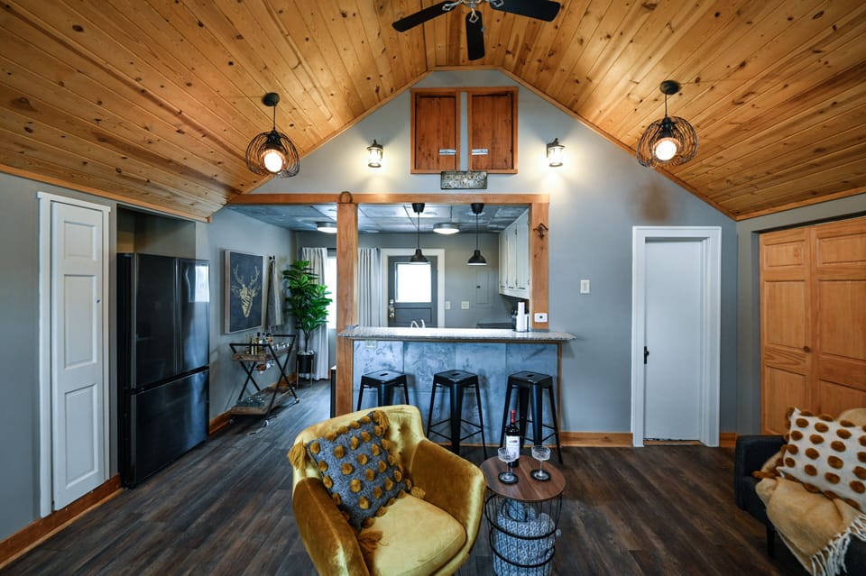 Cozy up in this rustic-modern retreat where warm wood ceilings and thoughtful lighting create your perfect home base for relaxation.
