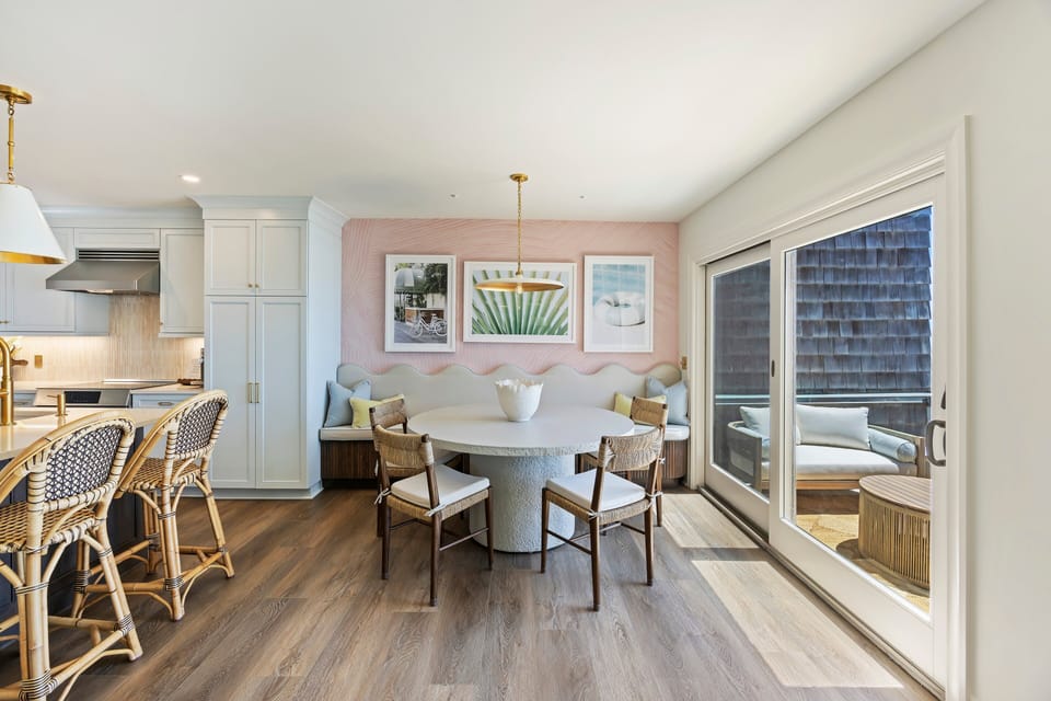 Fashionably decorate dining space  with bench seating and 4 chairs. 2 additional bar stools for seating