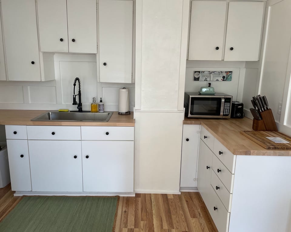 Full kitchen with all cooking equipment and eating utensils.