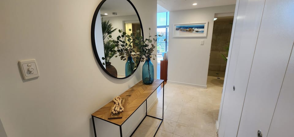 Entrance hall with European laundry facilities hidden behind cupboards
