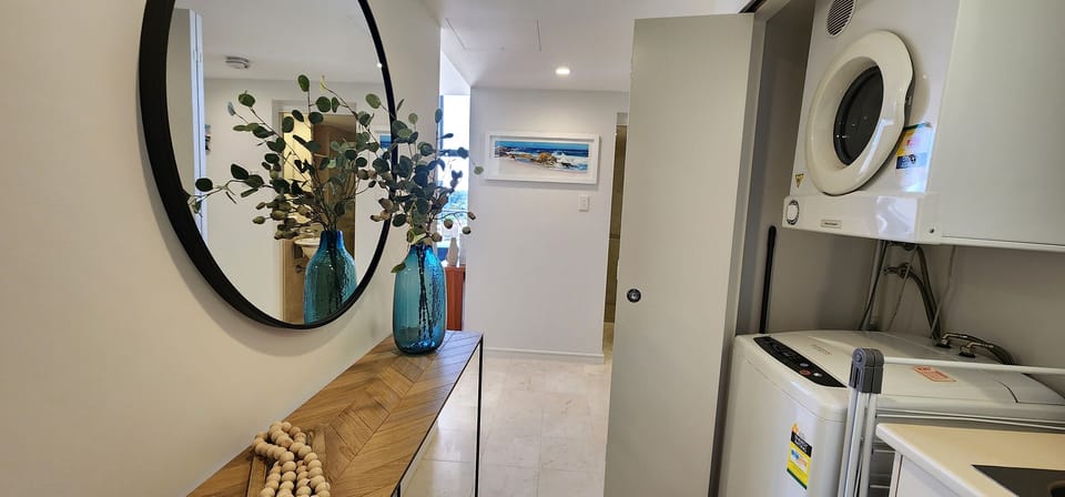 Entrance hall with European laundry facilities hidden behind cupboards
