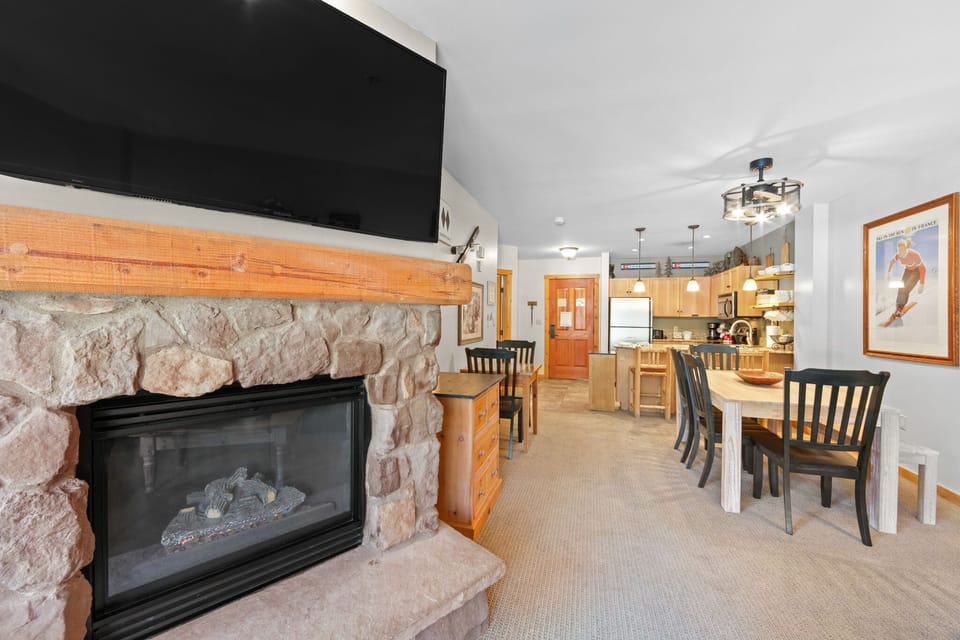Gather around your cozy stone fireplace for movie nights, then share meals at the dining table overlooking your fully-equipped kitchen.
