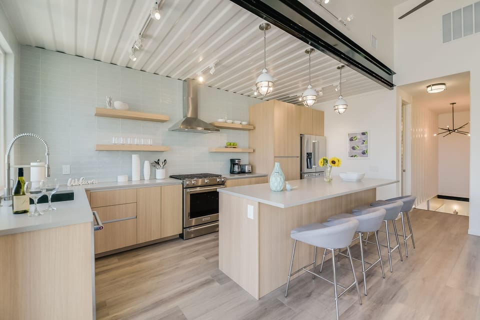 Your modern kitchen features sleek wood cabinets, quartz countertops, and a spacious island where you'll craft meals and connect with loved ones.