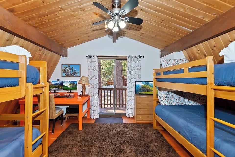 Second bedroom with workspace with monitor and connections, and balcony. 