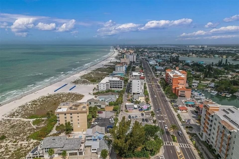 Beach access is 30 steps away from the back of the yellow house 