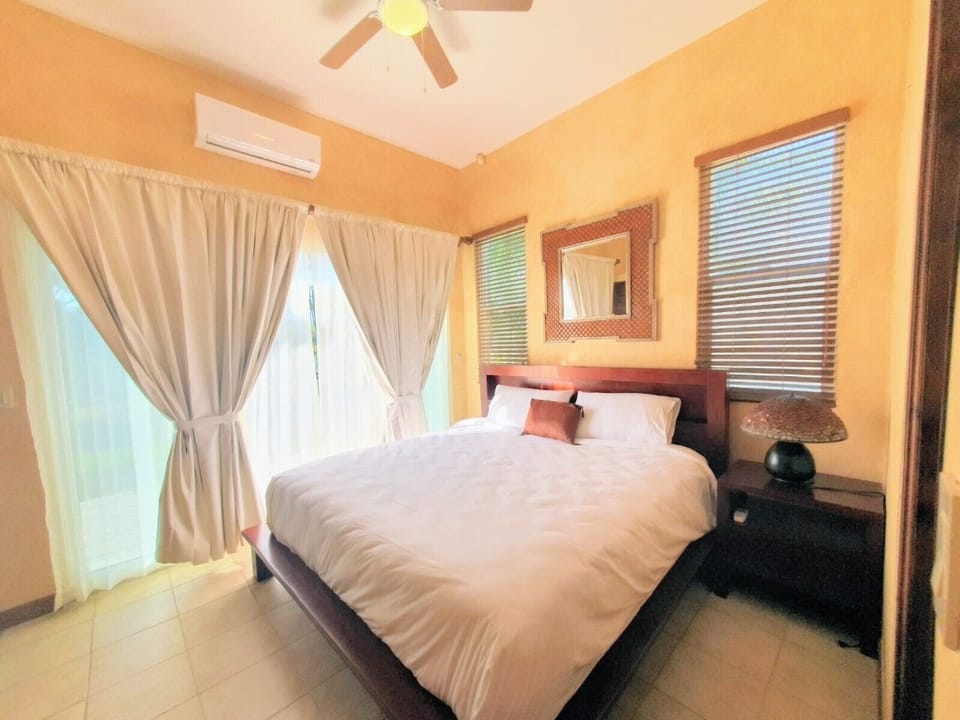 Second master room, king size bed, TV, full bathroom with shower and balcony.