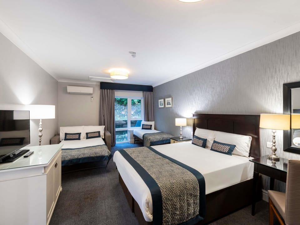 Desk, laptop workspace, blackout drapes, iron/ironing board