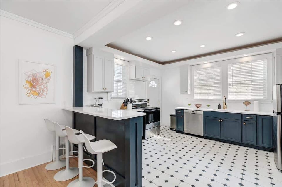 Bright kitchen with bar stools and open layout.