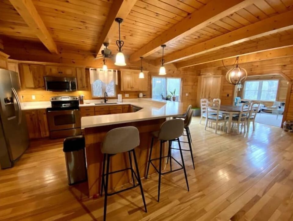 Huge bar countertop that seats 6 with dining table for 6 nearby.