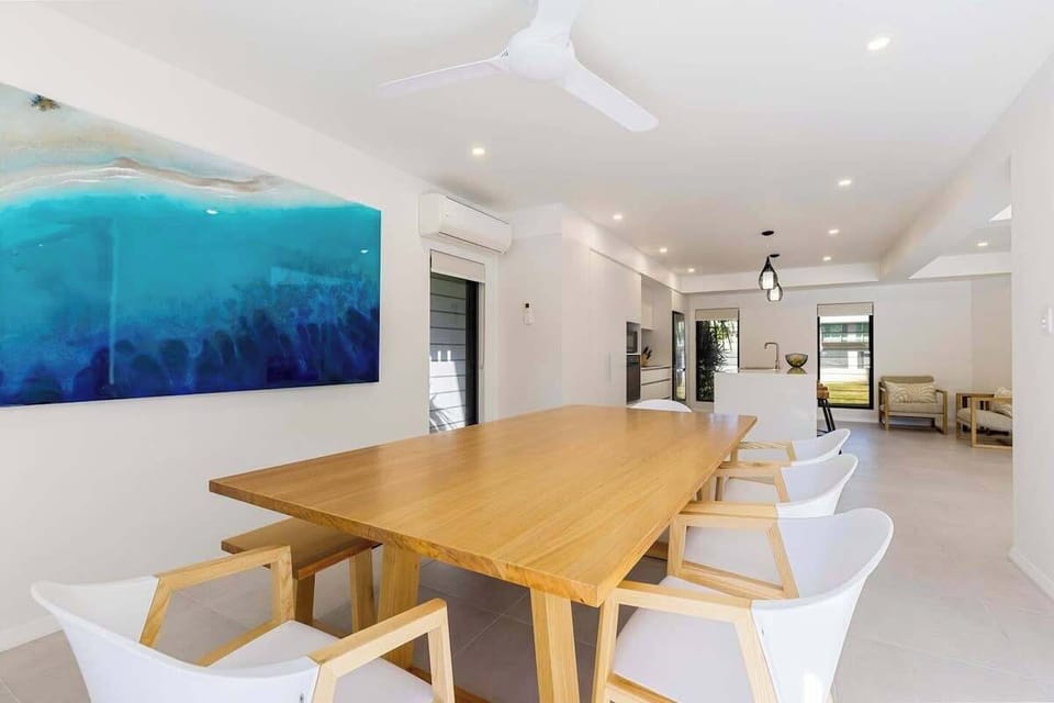 The oversized dining table seats all 10 guests. Open the sliding doors and let the sea breezes roll through.