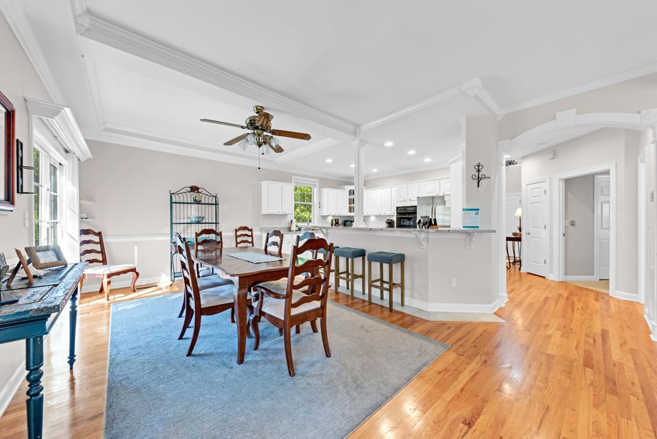 The dining area is open to the kitchen. The breakfast bar has stool seating