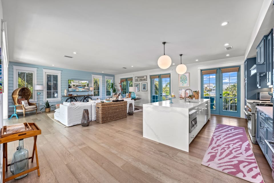 Gather in a bright living room where soft coastal hues welcome every guest.