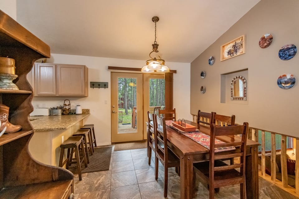 When you walk through the front door you will pass the main living area and see the dining area and the kitchen and be lead to the back deck. 