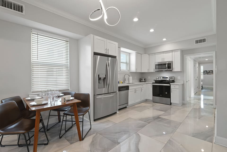 Dining Area- place settings for 4, extra seating in closet, stylish marble tile