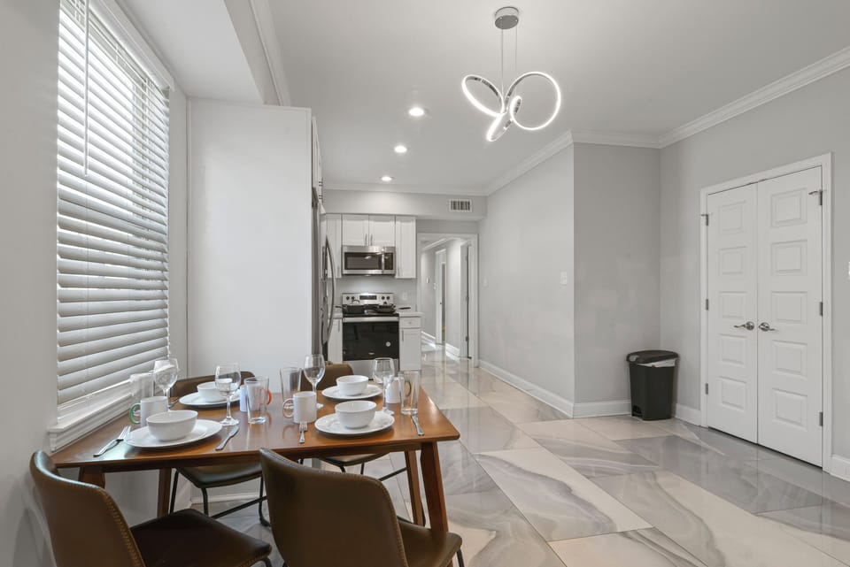 Dining Area- place settings for 4, extra seating in closet, stylish marble tile
