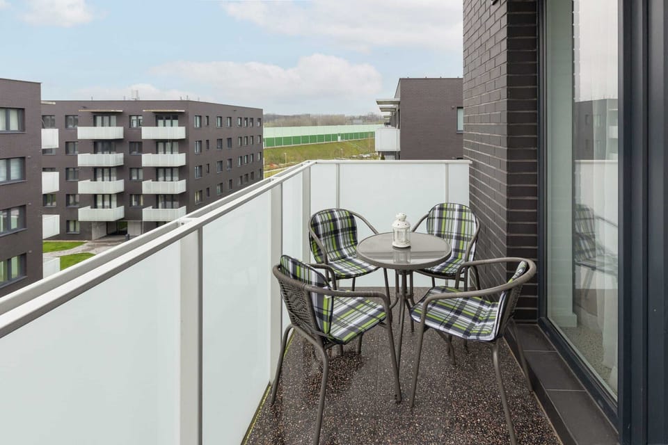 Private balcony with a small table and chairs, offering a relaxing space to enjoy the fresh air and outdoor views.
