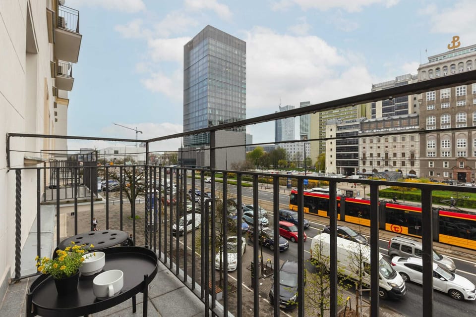 Balcony with a view of the bustling city street, perfect for enjoying a morning coffee or fresh air.
