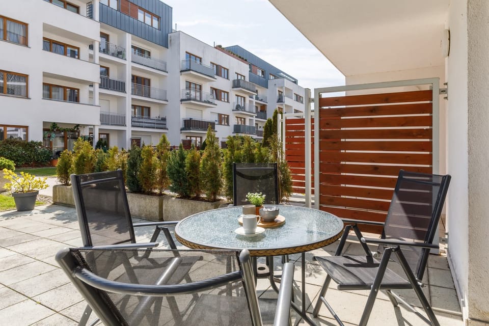 An outdoor terrace with a table and chairs, ideal for enjoying meals or relaxing outdoors.