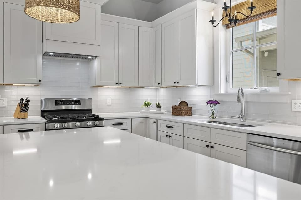 - Cook like a pro in this sleek, fully equipped kitchen with stainless steel appliances - Crisp white cabinetry, subway tile, & extra counter space bring both style & function - Fresh flowers, natural light, & modern finishes elevate every cooking mo