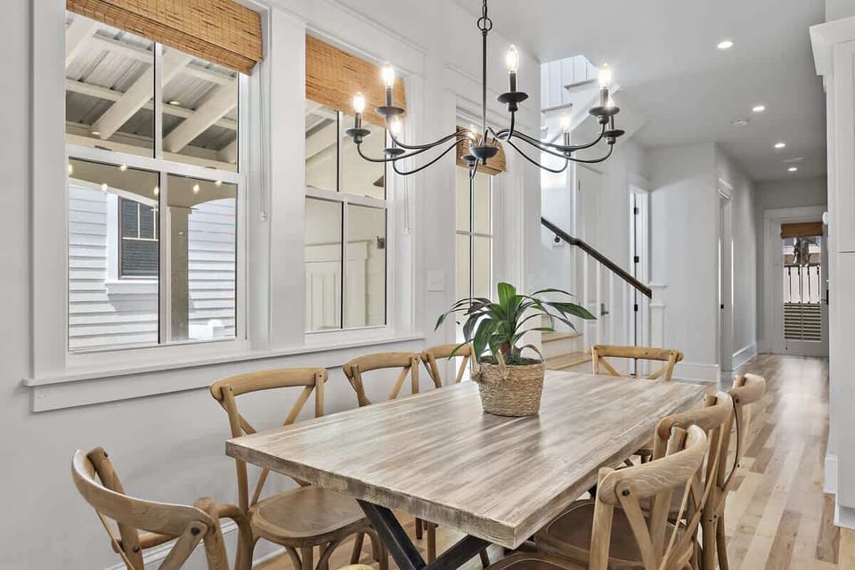 - Gather around this beautiful wood dining table with seating for up to 8 guests - Natural light pours in through the windows, creating a warm, welcoming atmosphere - Whether it’s a pancake breakfast or holiday feast, this space is made for connectio