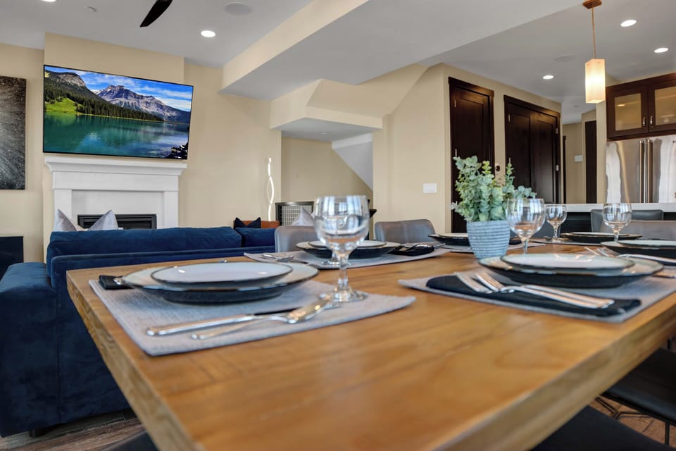 The wood dining table is complete with all the place settings you need to have a nice meal.