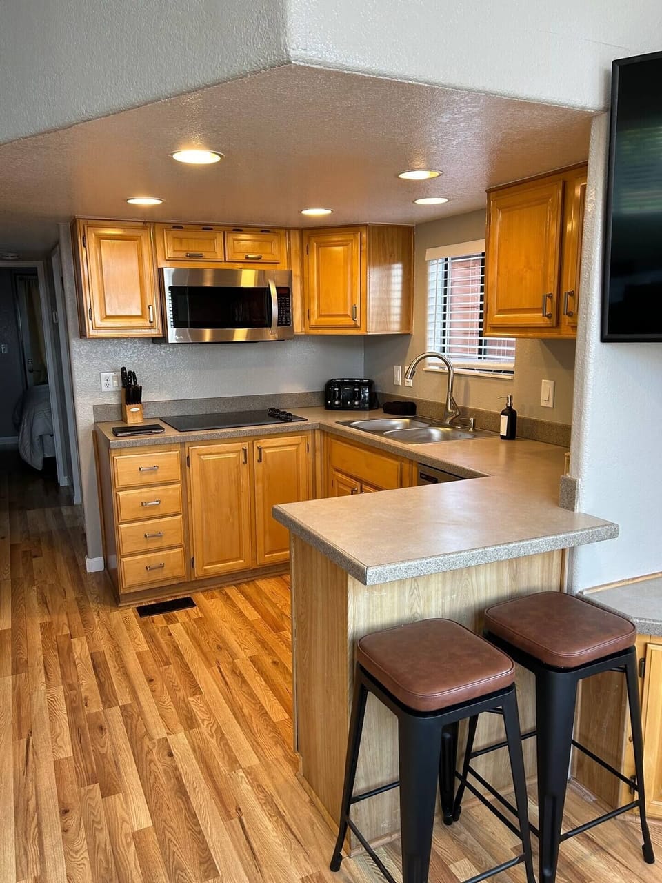 Fully Stocked Kitchen with Induction Stove top, Microwave, and Array of Spices to Cook with